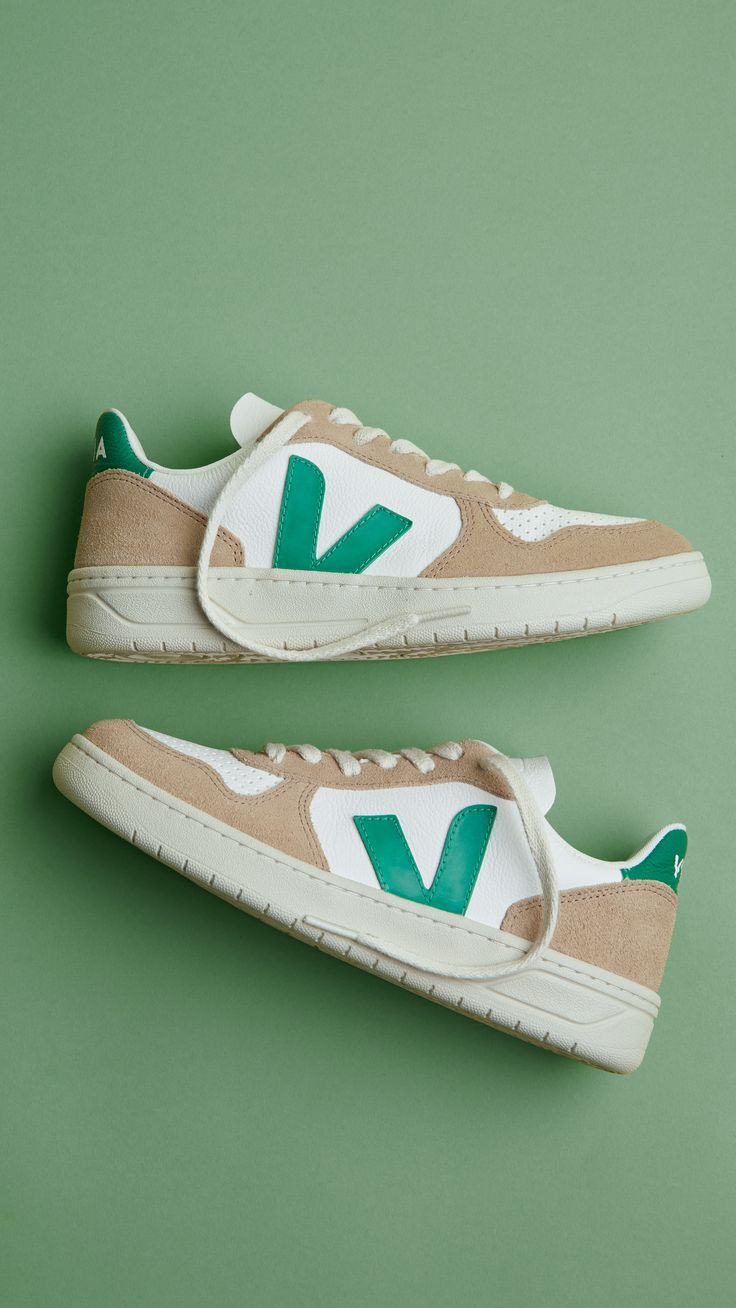 Beige and green sneakers on green background.